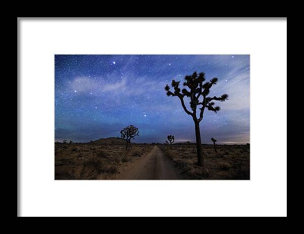 Tranquility Framed Print featuring the photograph A Desert Road And Joshua Trees At Night by Daniel J Barr