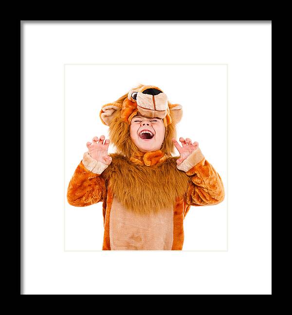 Child Framed Print featuring the photograph A little girl dressed up in a lion costume by Adipelcz