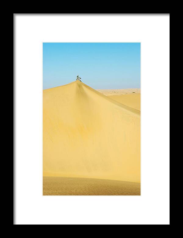 Absense Framed Print featuring the photograph A Man Sits Atop A Dun In The Namib by Jen Judge