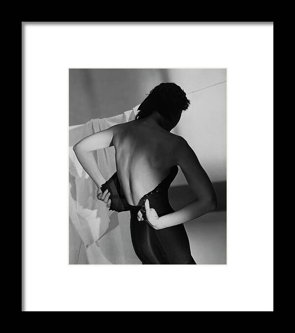 Fashion Framed Print featuring the photograph A Model Fastening Her Brassiere by Horst P. Horst