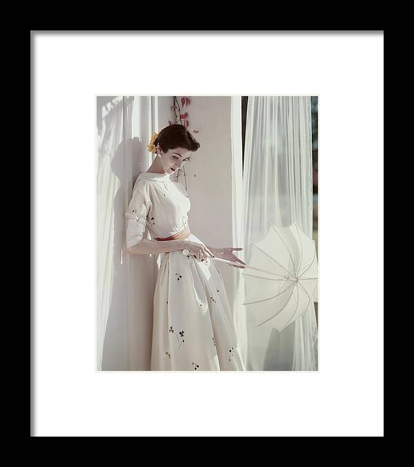 Fashion Framed Print featuring the photograph A Model Holding A Parasol by Horst P. Horst