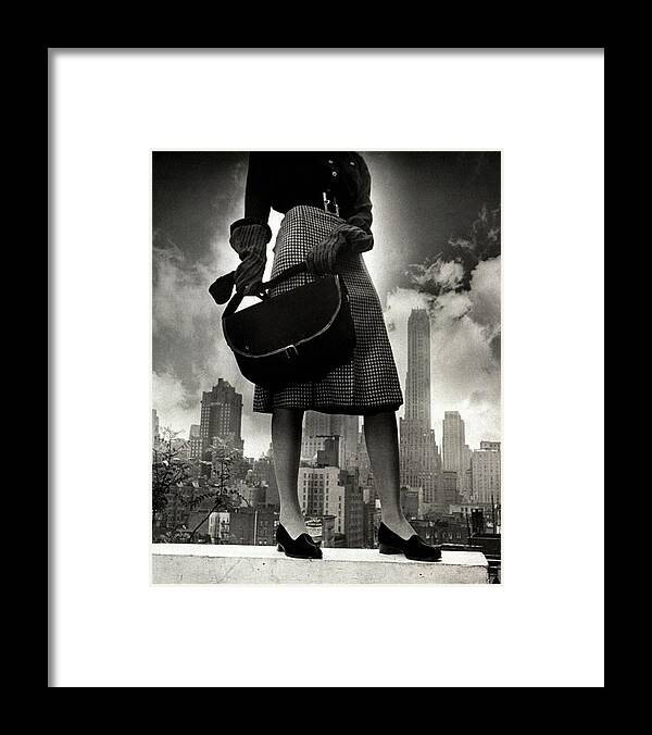 Fashion Framed Print featuring the photograph A Model On A Ledge by John Rawlings
