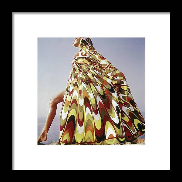 Exterior Fashion Lifestyle Outdoors Daytime Side View One Person People Female Model Young Woman Young Adult Young Adult Woman Lake Tanganyika Colorful Cover-up Emilio Pucci Pucci Africa Posing 1960s Style #condenastvoguephotograph January 1st 1965 Framed Print featuring the photograph A Model Posing In A Colorful Cover-up by Henry Clarke