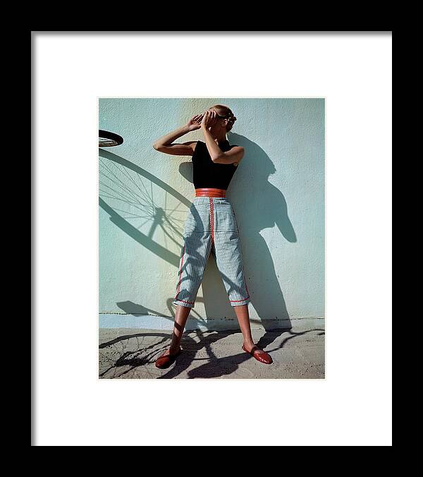Fashion Framed Print featuring the photograph A Model Wearing A Turtleneck And Capri Pants by Serge Balkin