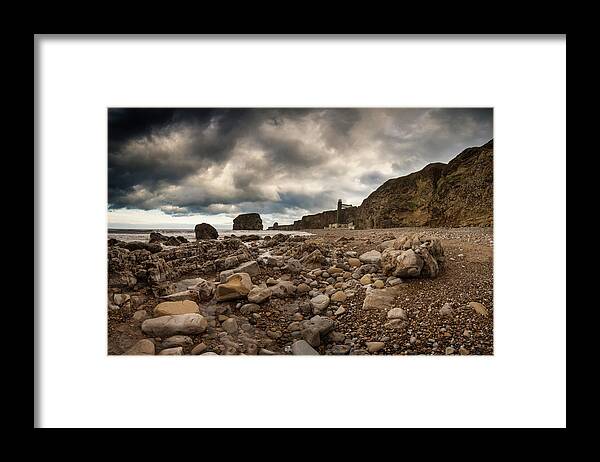 Water's Edge Framed Print featuring the photograph A Rocky Beach Along The Waters Edge by John Short / Design Pics