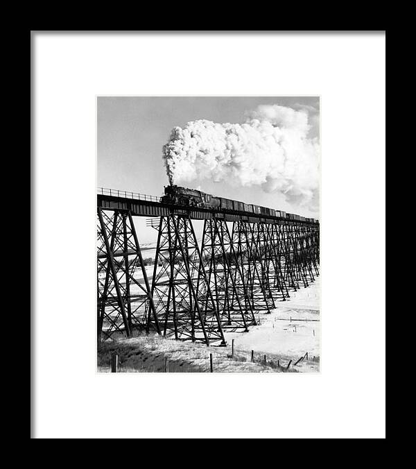1930's Framed Print featuring the photograph A Steam Engine On Trestle by Underwood Archives