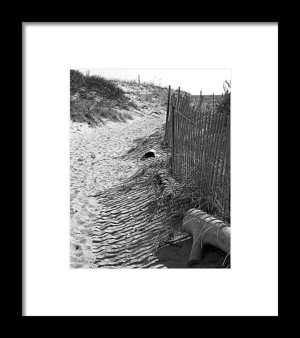 Beach Retaining Fence Framed Print featuring the photograph A Stroll In The Sand by Jeff Folger