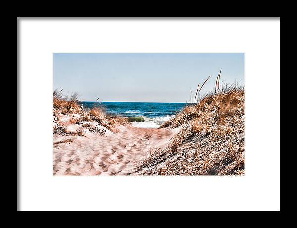 Beach Retaining Fence Framed Print featuring the photograph A walk out to the water by Jeff Folger