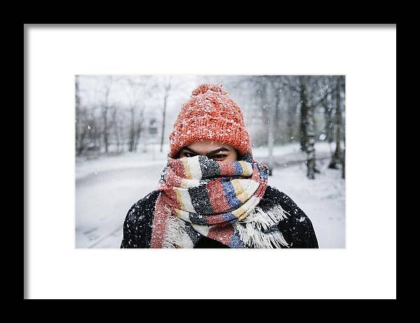 Tranquility Framed Print featuring the photograph A young woman enjoying snowfall in Amsterdam by Paulo Amorim