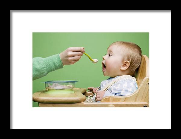 Human Arm Framed Print featuring the photograph Adult feeding baby by Image Source