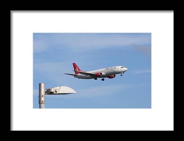 England Framed Print featuring the photograph AlbaStar Passenger jet landing at Gatwick Airport by Pejft