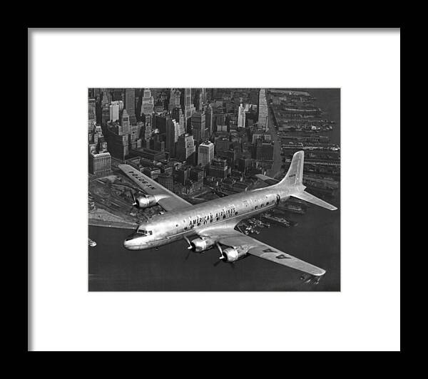 1940's Framed Print featuring the photograph American DC-6 Flying Over NYC by Underwood Archives