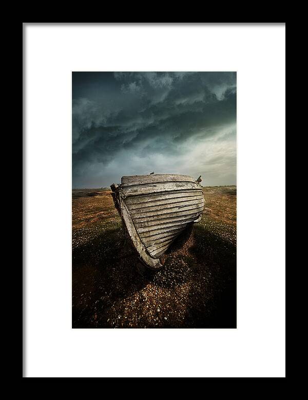 Boat Framed Print featuring the photograph An old wreck on the field. Dramatic sky in the background by Jaroslaw Blaminsky