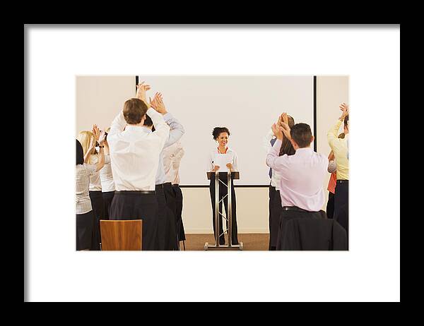 Young Men Framed Print featuring the photograph Audience applauding businesswoman at podium by Jacobs Stock Photography Ltd