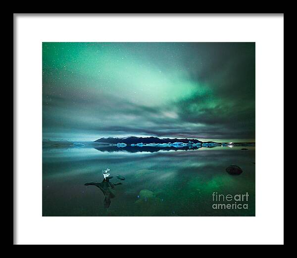Aurora Framed Print featuring the photograph Aurora borealis Northern lights over glacial lagoon in Iceland by Matteo Colombo