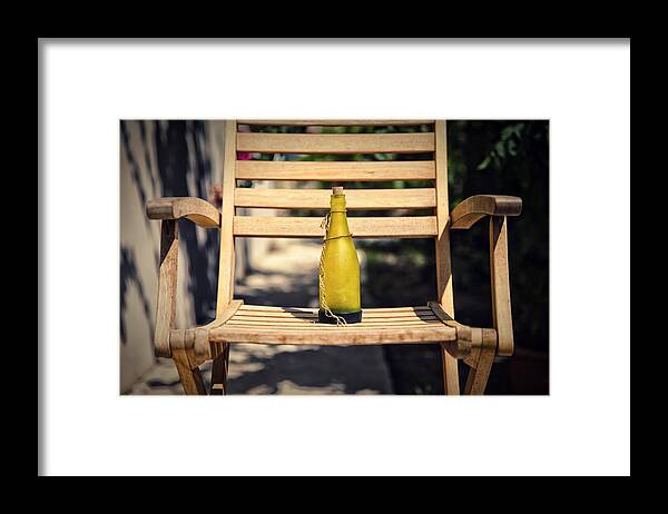 Wooden Framed Print featuring the photograph Bottle on wooden chair by Mike Santis
