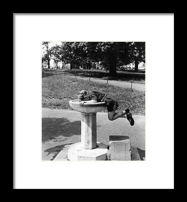 1930's Framed Print featuring the photograph Boy Drinking From Fountain by Underwood Archives
