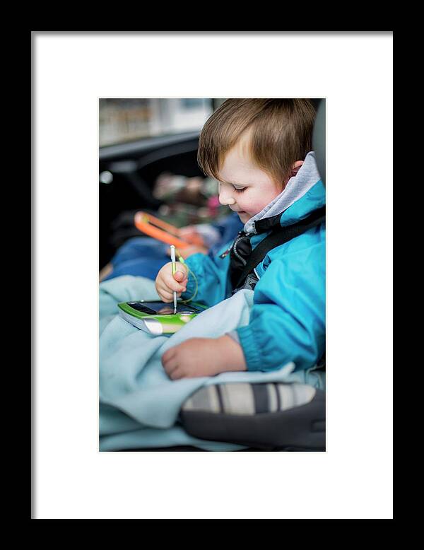 Photography Framed Print featuring the photograph Boy In Car Using Digital Device by Samuel Ashfield
