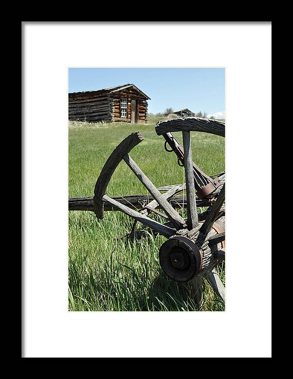 Montana Framed Print featuring the photograph Broken Wagon Wheel and Log Building in Montana's Nevada City by Bruce Gourley