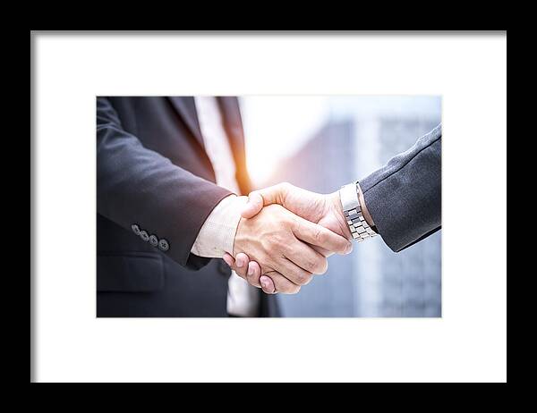 Working Framed Print featuring the photograph Business cooperation by Virojt Changyencham