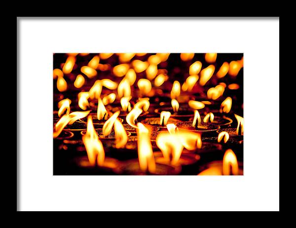 Milarepa Framed Print featuring the photograph candle light in Boudnath stupa by Raimond Klavins