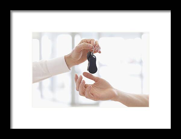 Young Men Framed Print featuring the photograph Car salesman handing keys to customer by Photo_Concepts