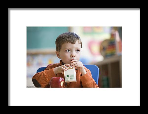 4-5 Years Framed Print featuring the photograph Caucasian boy eating lunch in classroom by Jose Luis Pelaez Inc