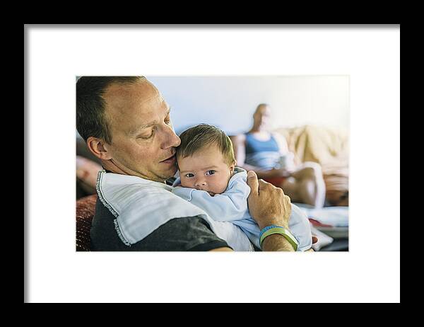 Mature Adult Framed Print featuring the photograph Caucasian father burping baby boy in living room by Inti St Clair