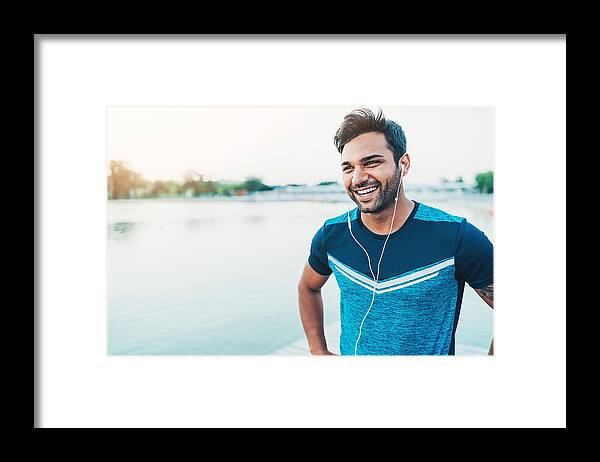 Young Men Framed Print featuring the photograph Cheerful young athlete outdoors by the river by Pixelfit