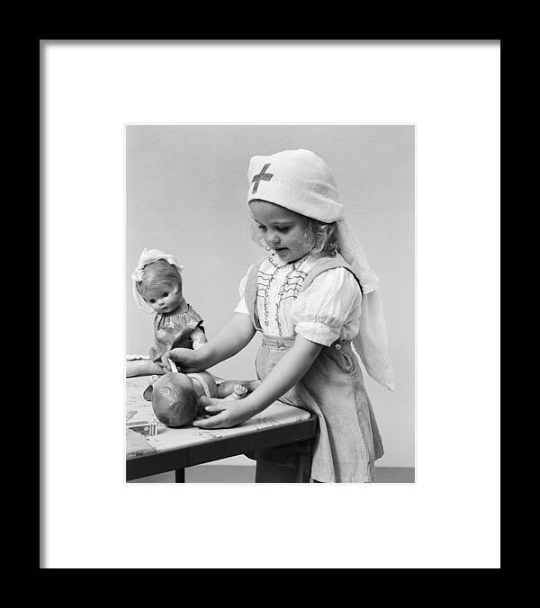 1940s Framed Print featuring the photograph Child Playing Doctor With Dolls, C.1940s by H. Armstrong Roberts/ClassicStock