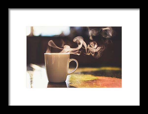 Breakfast Framed Print featuring the photograph Close up of steaming cup of coffee or tea on vintage table - early morning breakfast on rustic background by Alina Rosanova