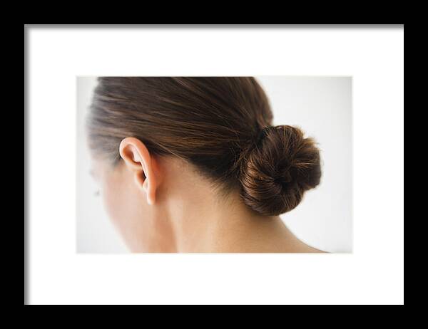 People Framed Print featuring the photograph Close up of woman wearing bun in hair by JGI/Jamie Grill