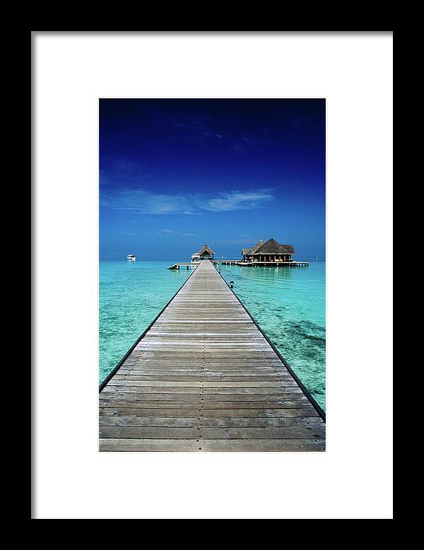 Tranquility Framed Print featuring the photograph Club Med Kani, Long Pier Surrounded By by Izzet Keribar