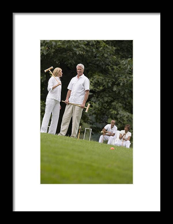 Mid Adult Women Framed Print featuring the photograph Couple playing croquet by Comstock Images