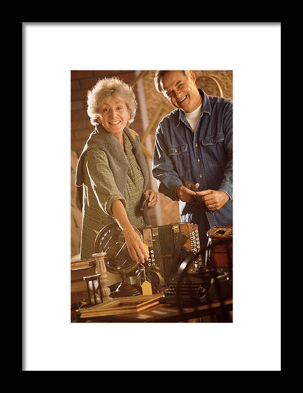 Mature Adult Framed Print featuring the photograph Couple with antiques by Comstock