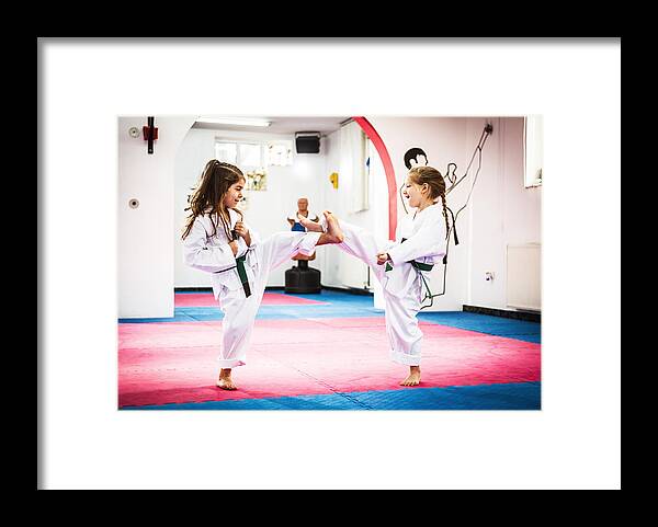 4-5 Years Framed Print featuring the photograph Cute girls on Taekwondo training by Drazen_