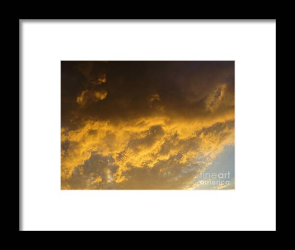 Dark Golden Clouds At Sunset. Framed Print featuring the photograph Dark Golden Clouds at Sunset. by Robert Birkenes