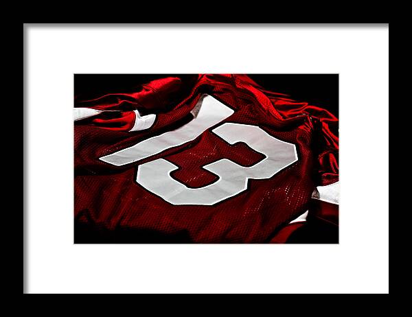 American Football Uniform Framed Print featuring the photograph Dark red and white jersey with the number thirteen on it by Jgareri