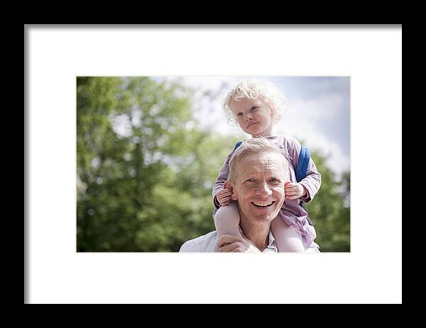 North Holland Framed Print featuring the photograph Daughter on father's shoulders, holding his ears by Lucy Lambriex