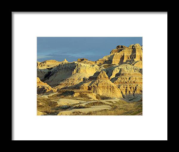 Badlands National Park South Dakota Sd Parks North America American Badland Landscape Landscapes Sandstone Sandy Formations Formation Bad Lands Sky Skies Dusk Neutral Beige Colors Rugged Beauty Scenic Scenery Hiking Travel Vacation Destinations Blue Rapid City Brown Lighting Light Dimensional Dimensions Photography Photos Artistic Art Unique Rocky Rock Rocks James Melissa Peterson Nature Outdoor Wilderness Adventure Wall Buttes Pinnacles Grass Prairie Southwestern Dynamic Golden Hour Unusual Framed Print featuring the photograph Dynamic Lighting by James Peterson