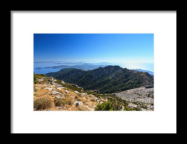 Elba Framed Print featuring the photograph Elba island against the sun by Antonio Scarpi