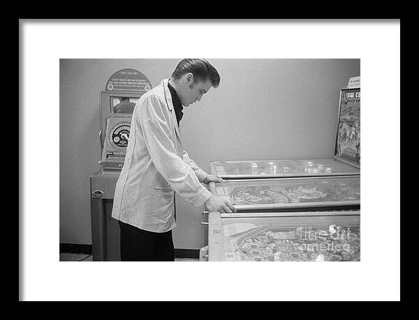 Elvis Framed Print featuring the photograph Elvis Presley playing Pinball 1956 by The Harrington Collection