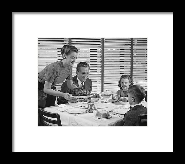 Mid Adult Women Framed Print featuring the photograph Family dinner, mother holding platter with roast on it by Stockbyte