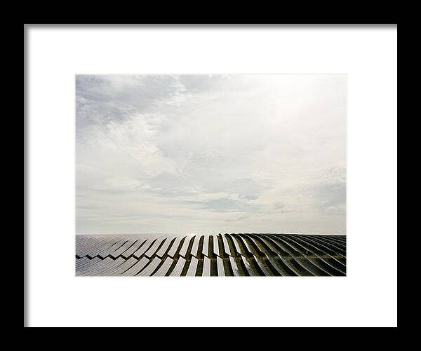 In A Row Framed Print featuring the photograph Field with solar panels by Muriel de Seze