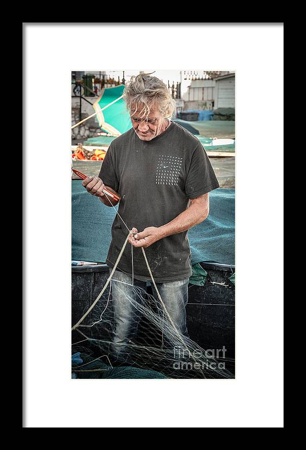 Anzio Framed Print featuring the photograph fisherman mending nets on Anzio harbour by Peter Noyce