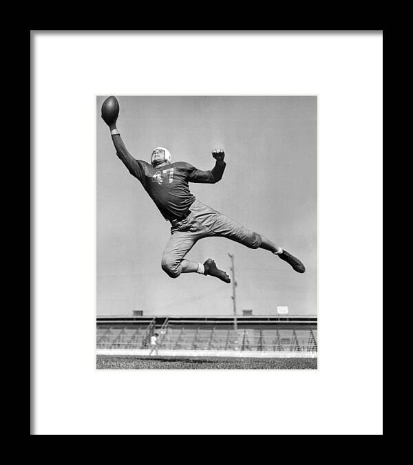 1945 Framed Print featuring the photograph Football Player Catching Pass by Underwood Archives
