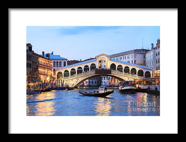 Venice Framed Print featuring the photograph Gondola in front of Rialto bridge at dusk Venice Italy by Matteo Colombo