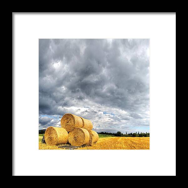 Field Stubble Framed Print featuring the photograph Hay Bales On Stubble Field With by Antimartina