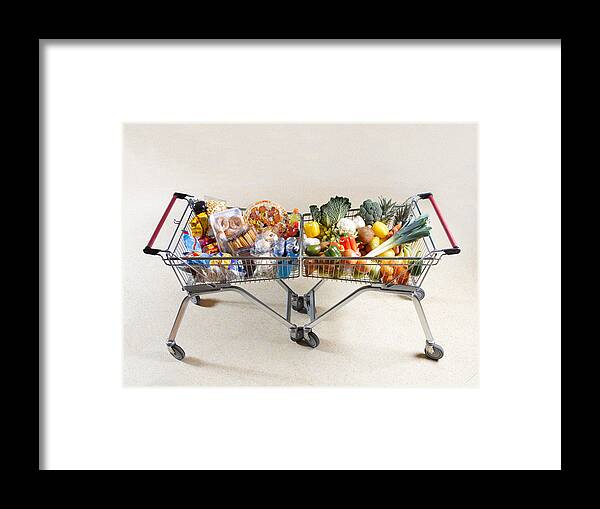 Unhealthy Eating Framed Print featuring the photograph Healthy vs unhealthy shopping trolleys by Peter Dazeley