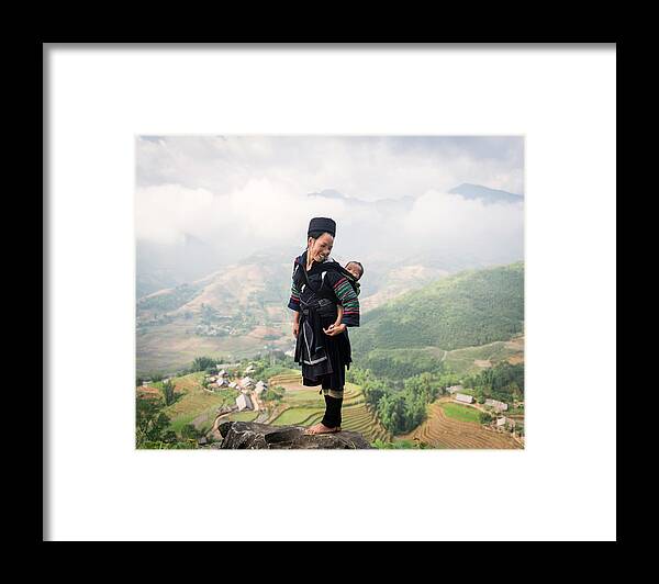 Looking Over Shoulder Framed Print featuring the photograph Hill Tribe Woman Carrying Baby On Her by Martin Puddy